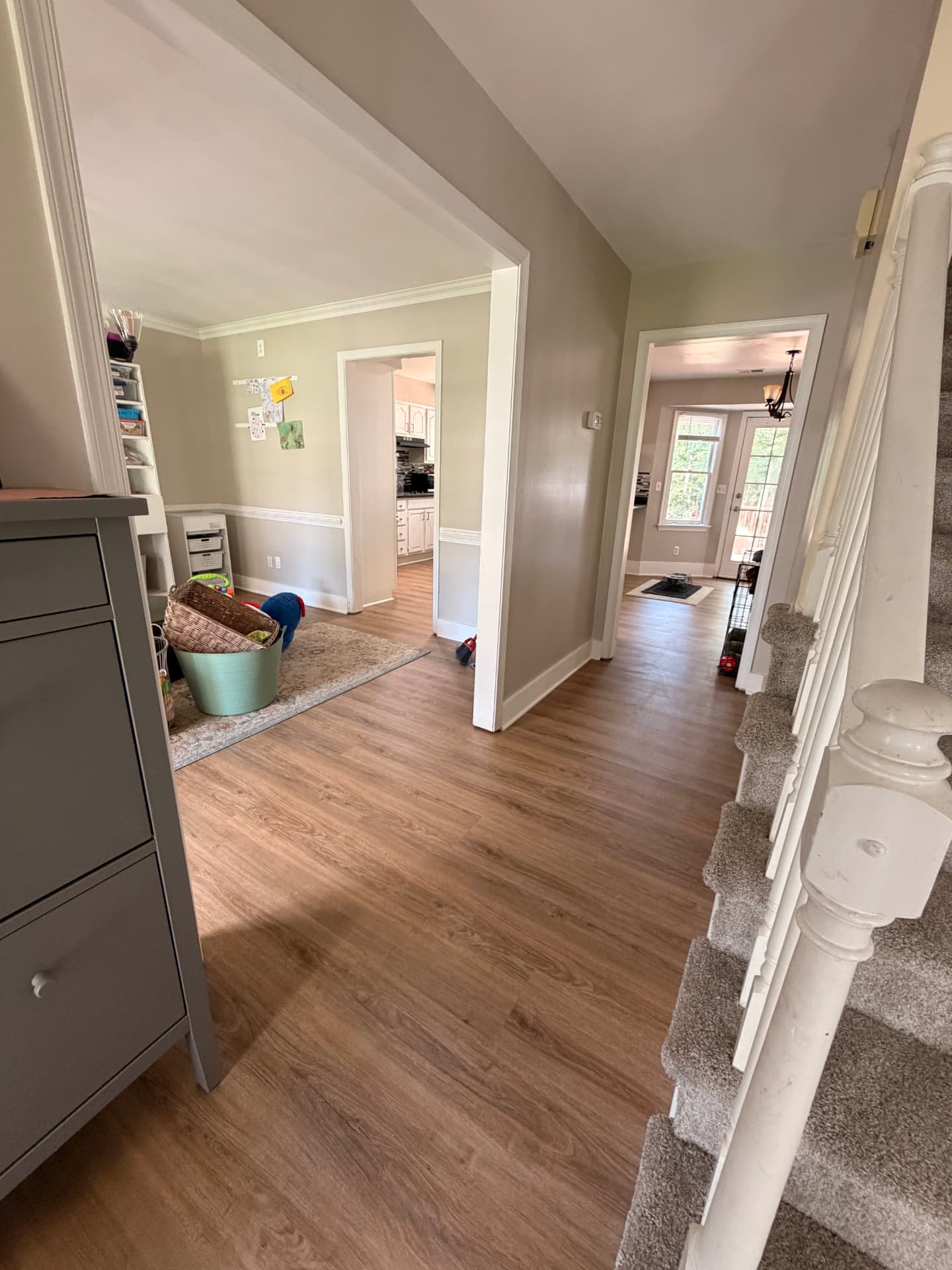 Completed LVP flooring through the same hallway and adjoining rooms