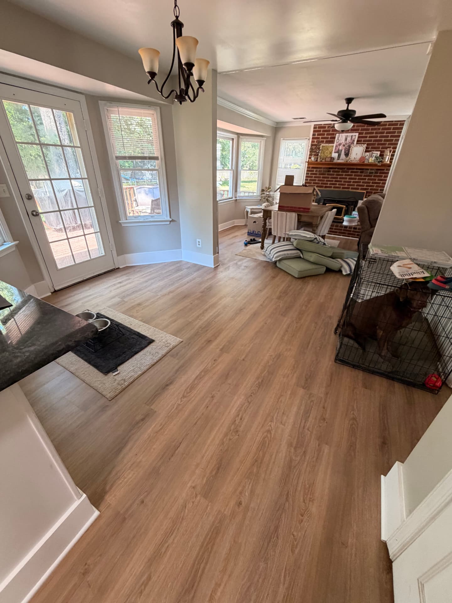 Completed LVP flooring extending from the kitchen into the living area